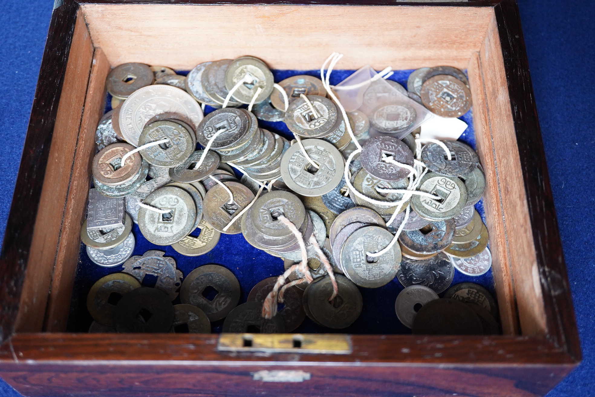 Chinese and Japanese coins, 16th to 20th century, including Chinese cast coins, Ming to Qing dynasty, Japanese Kan’ei Tsuho, in a rosewood box